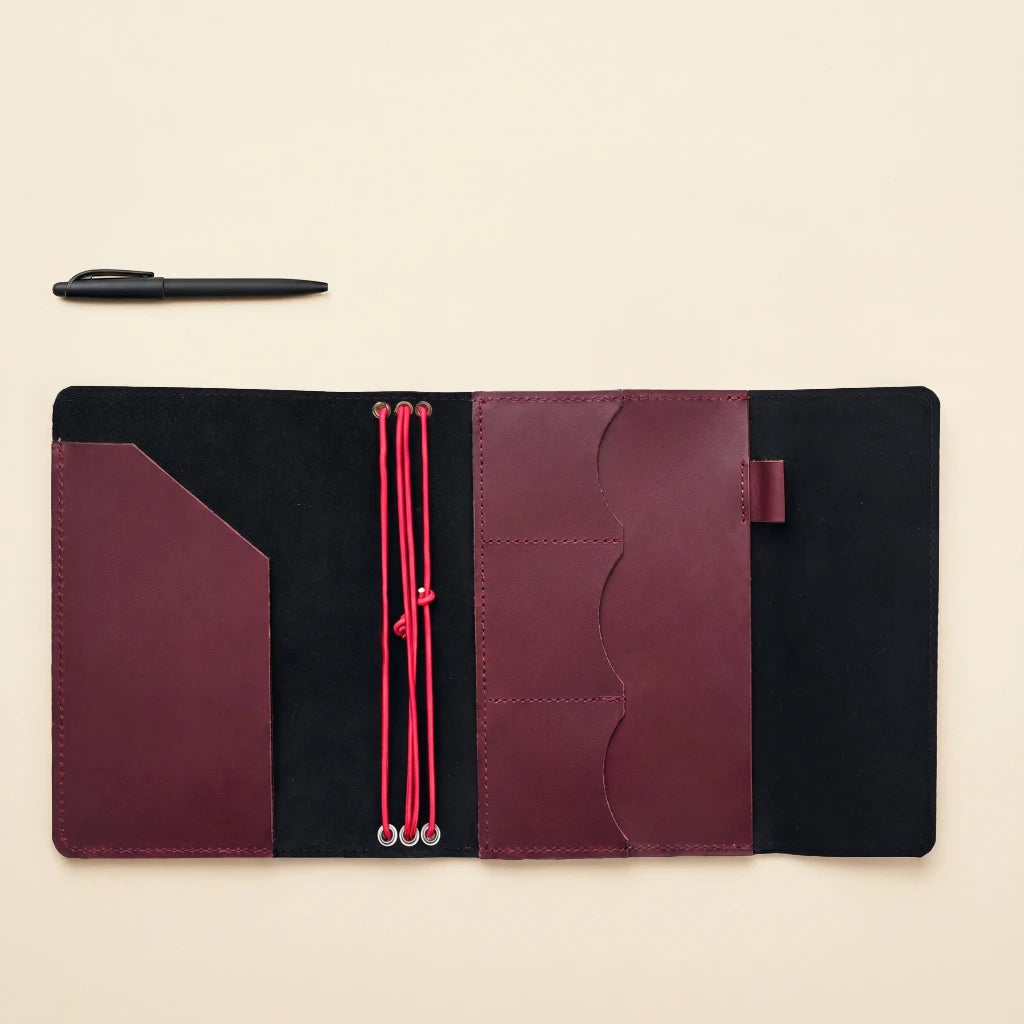 Artisan leather notebook holder with elastic straps and thoughtfully designed pocket storage
