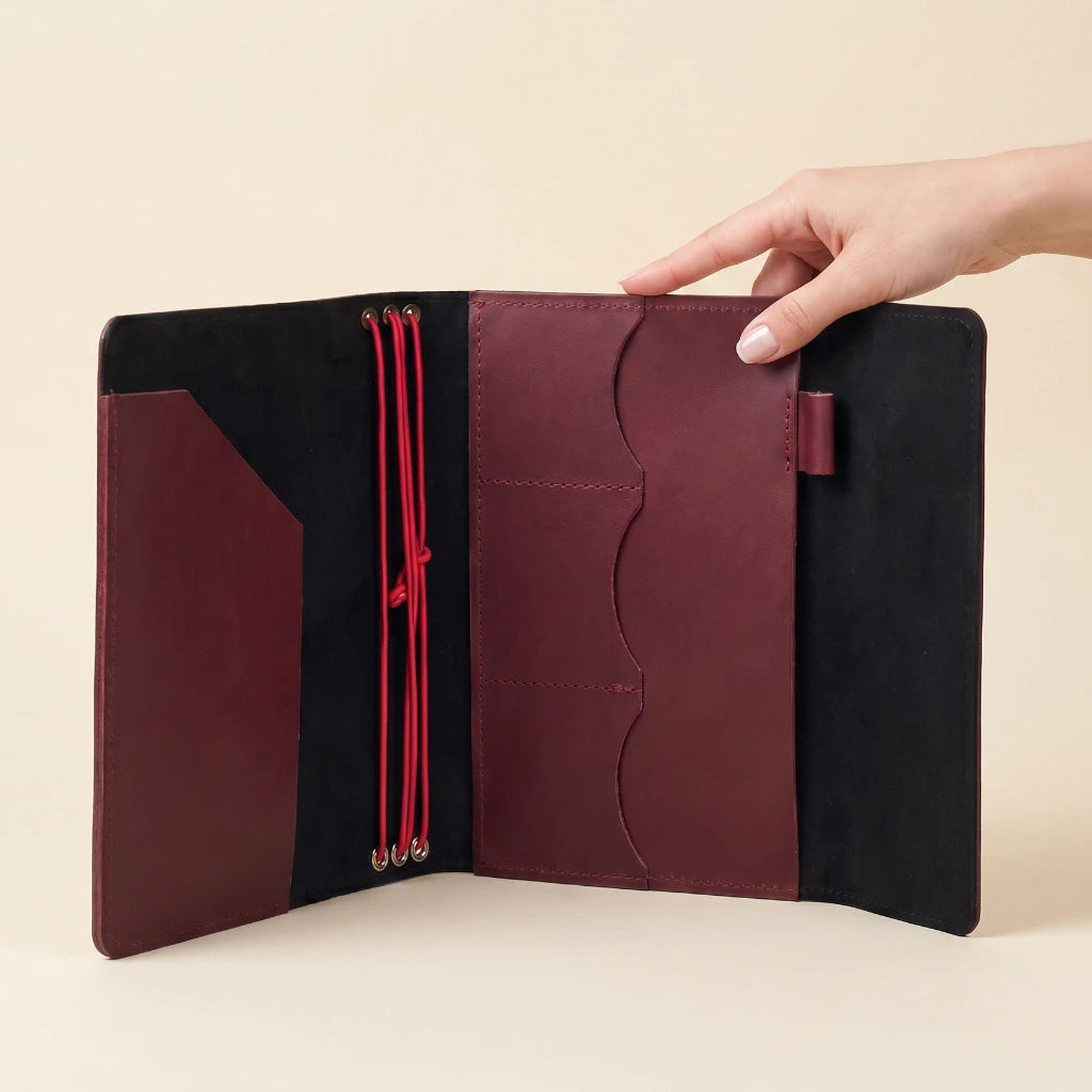 Leather notebook wrap with elastic bands and organized interior for daily essentials