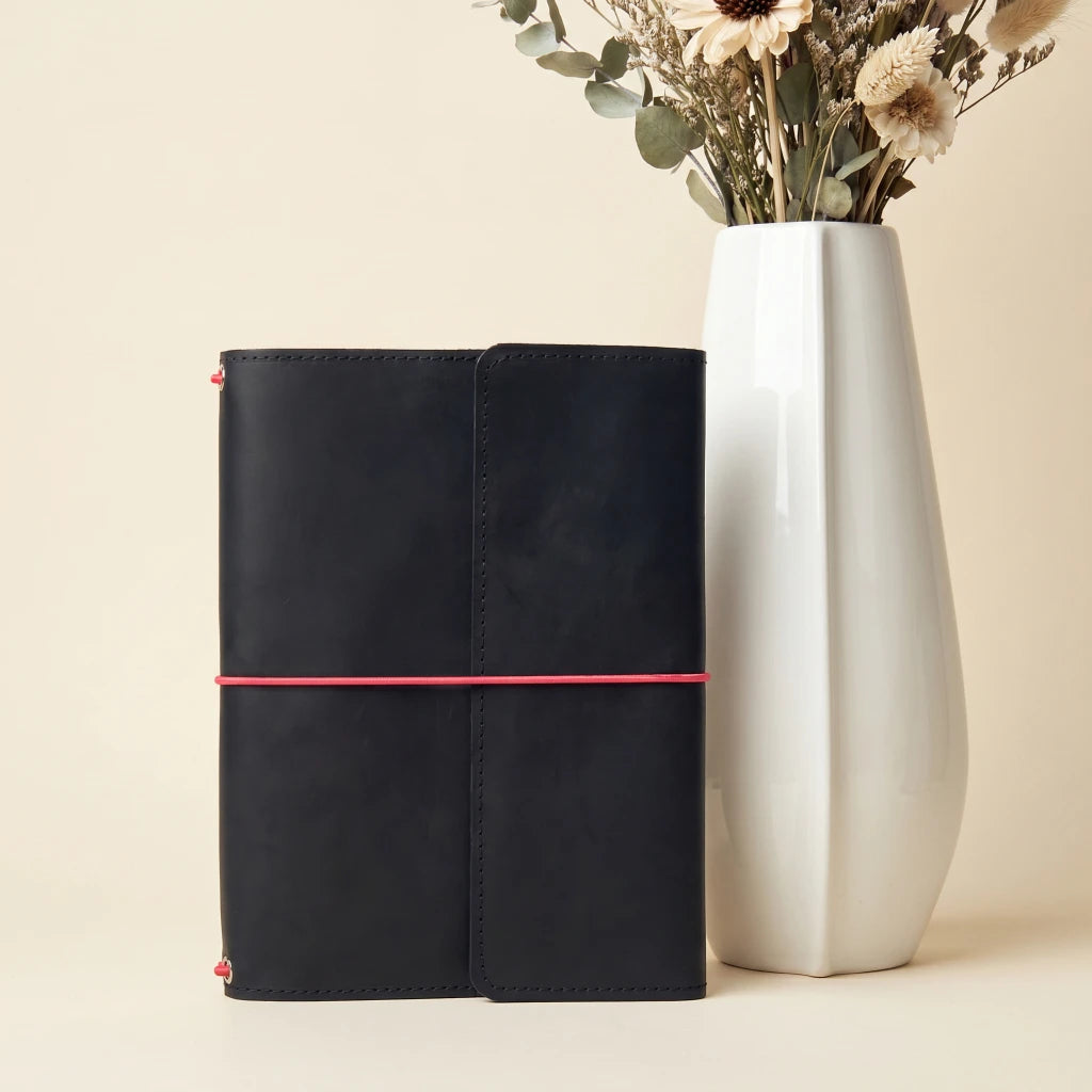 Personalized leather journal cover with elastic bands, interior pockets, and pen loop
