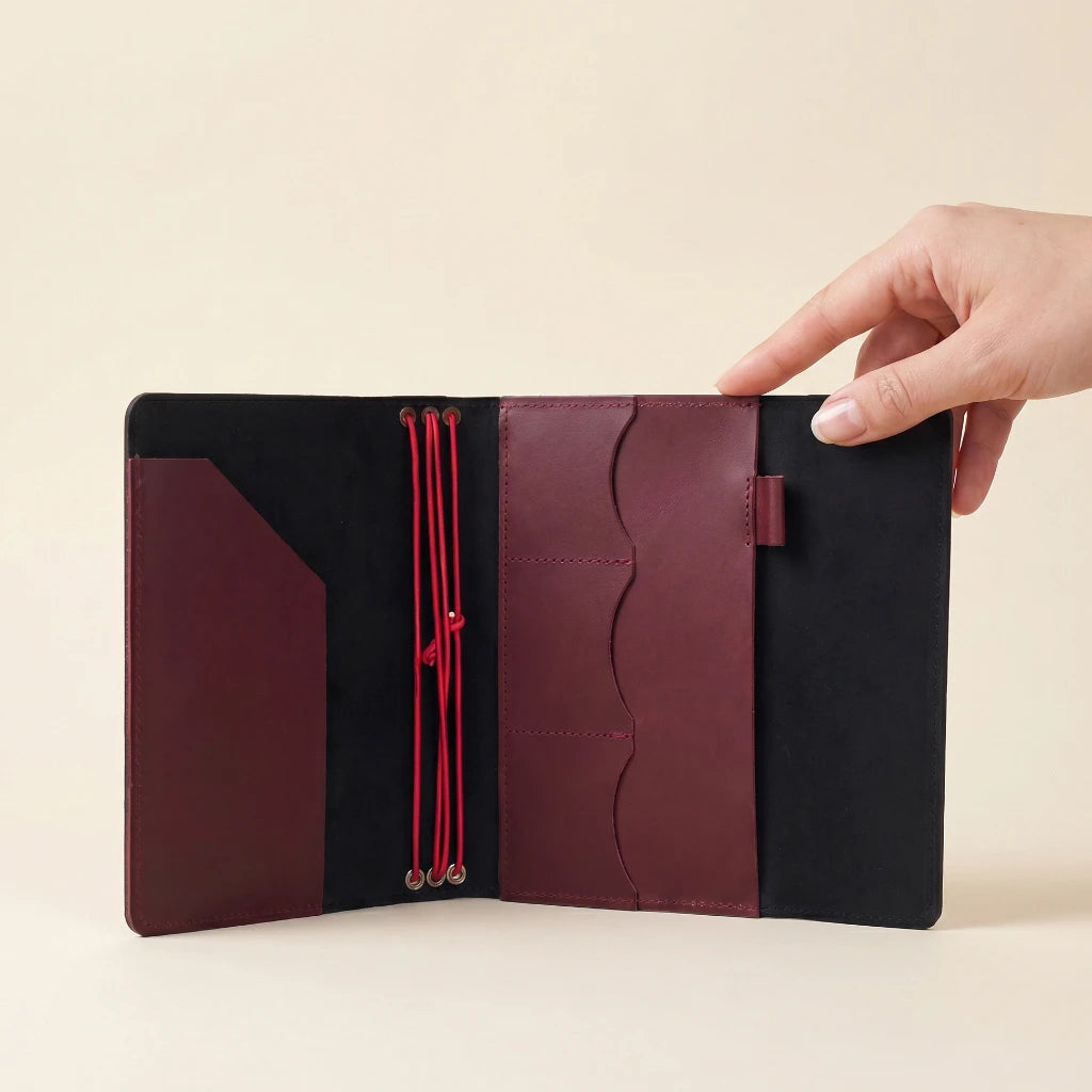 Handmade leather notebook case featuring elastic closure, pockets, and pen loop design
