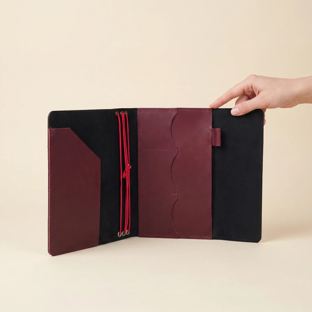 Classic leather notebook case with elastic fastening, pockets, and writing tool holder