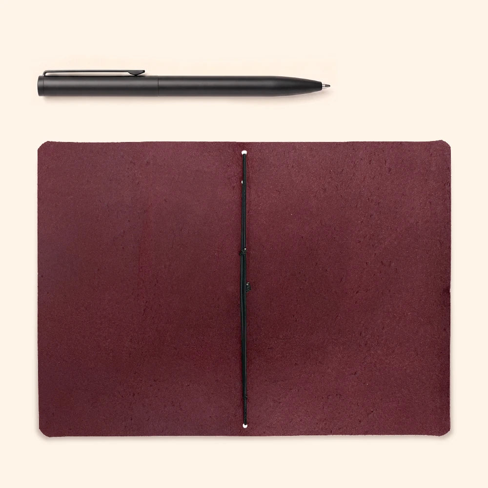Minimalist handmade leather notebook holder featuring one elastic band inside the cover.