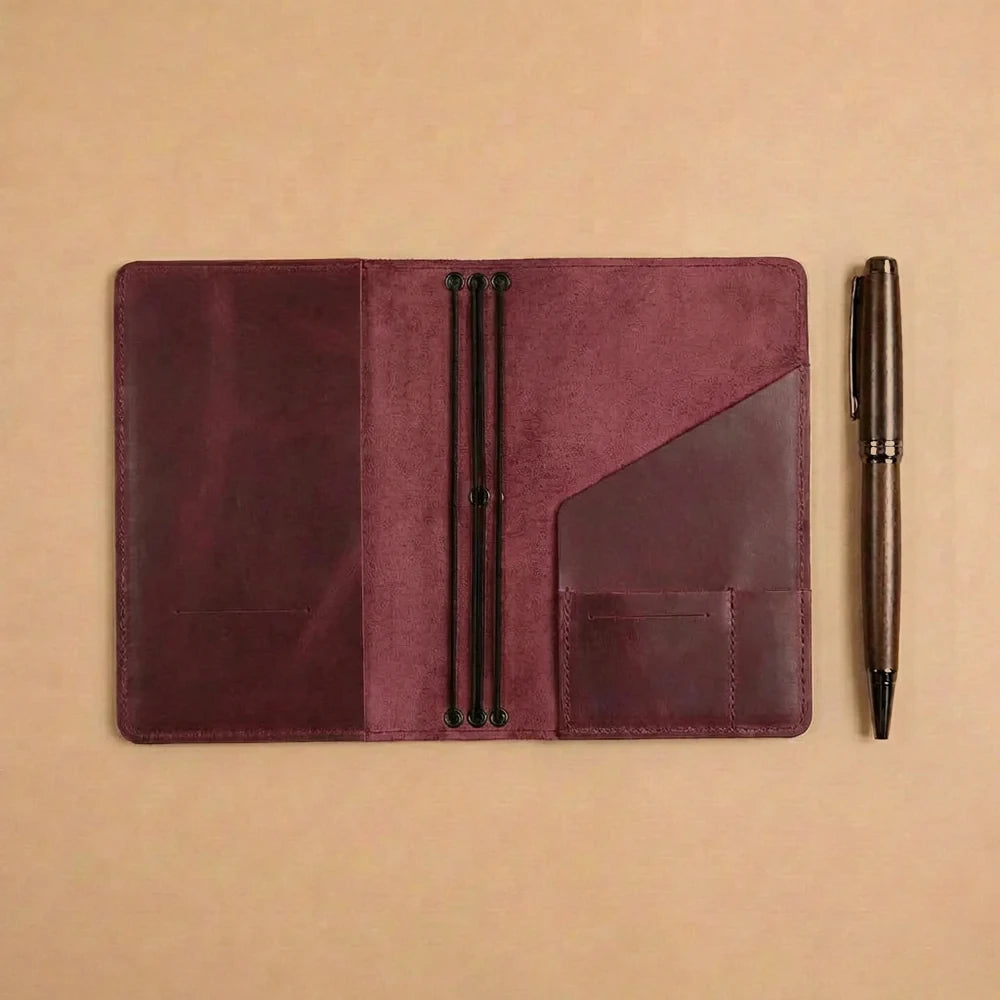 Handmade leather travel journal organizer featuring elastic bands and interior document compartments.