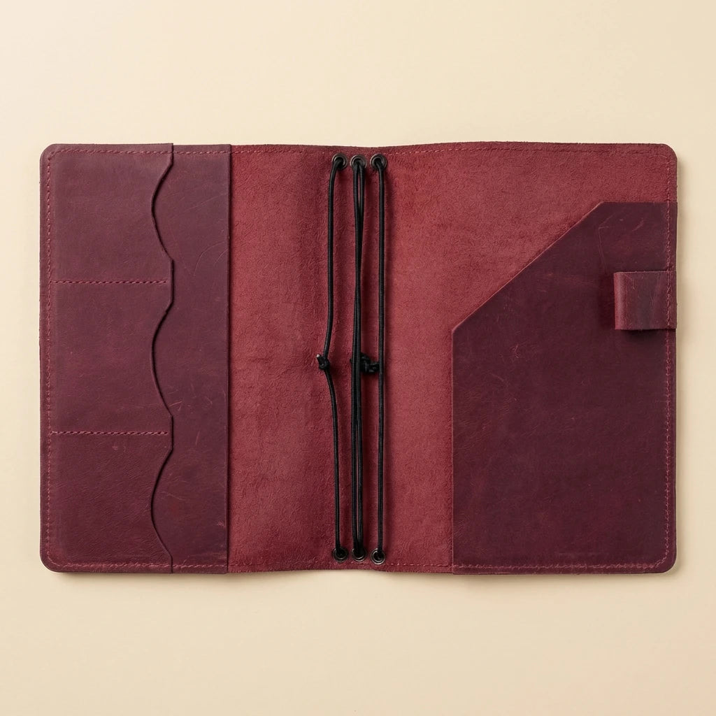 Maroon leather journal with a beige background
