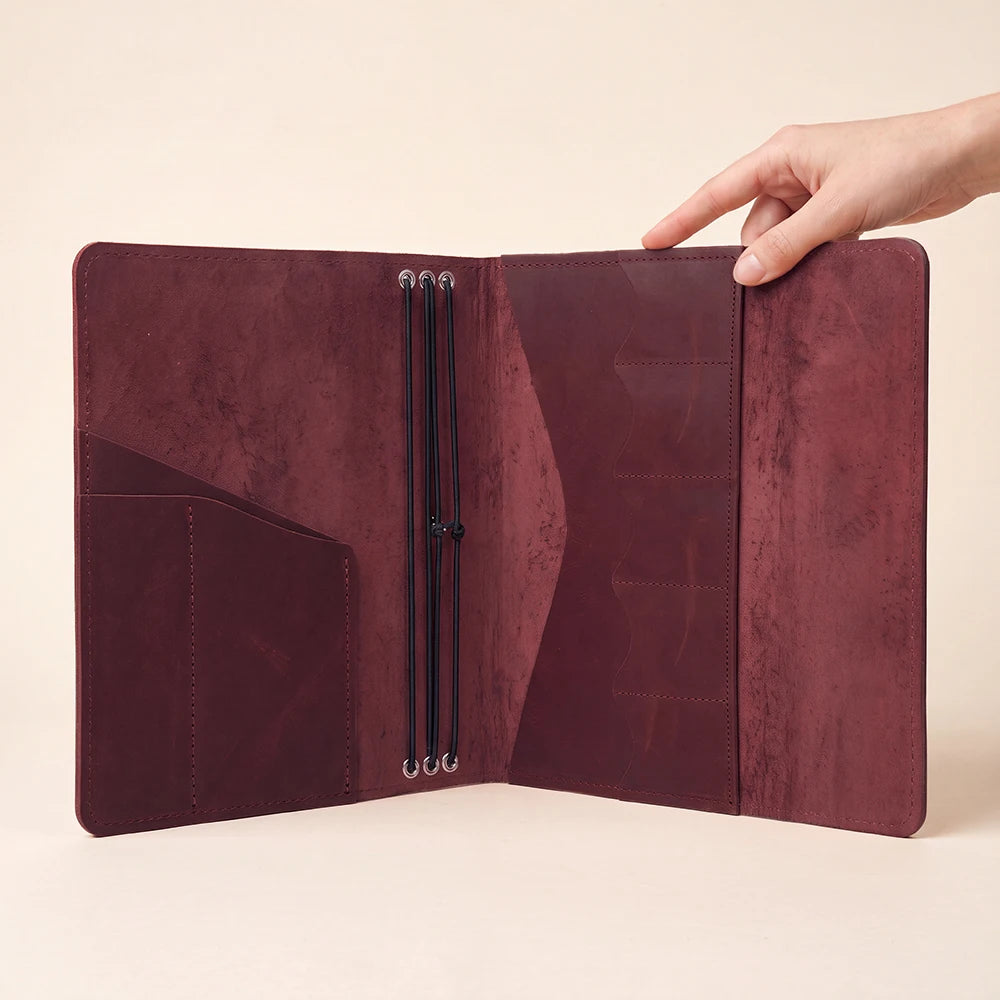 Handmade refillable notebook organizer showcasing premium leather texture and practical storage design.