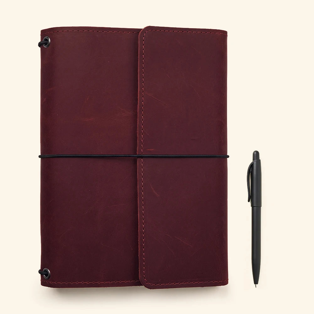 Genuine leather notebook holder featuring durable stitching and organized writing accessory compartments.