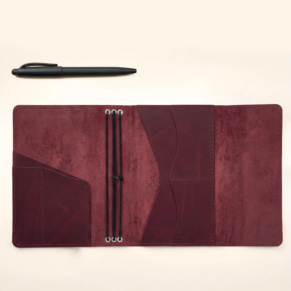 Genuine leather notebook organizer combining refillable functionality, elastic loops, and interior storage.