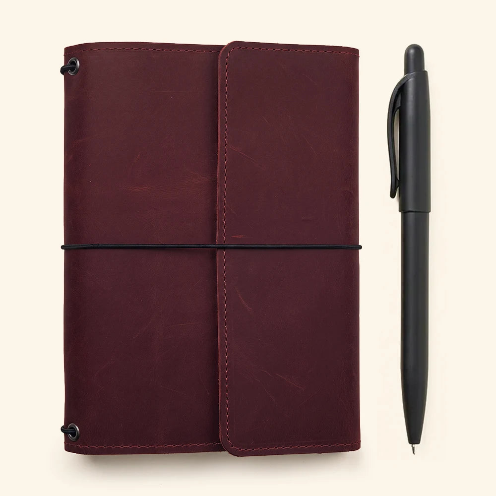 Handmade refillable leather notebook cover featuring pen holder and organized inner pocket layout.