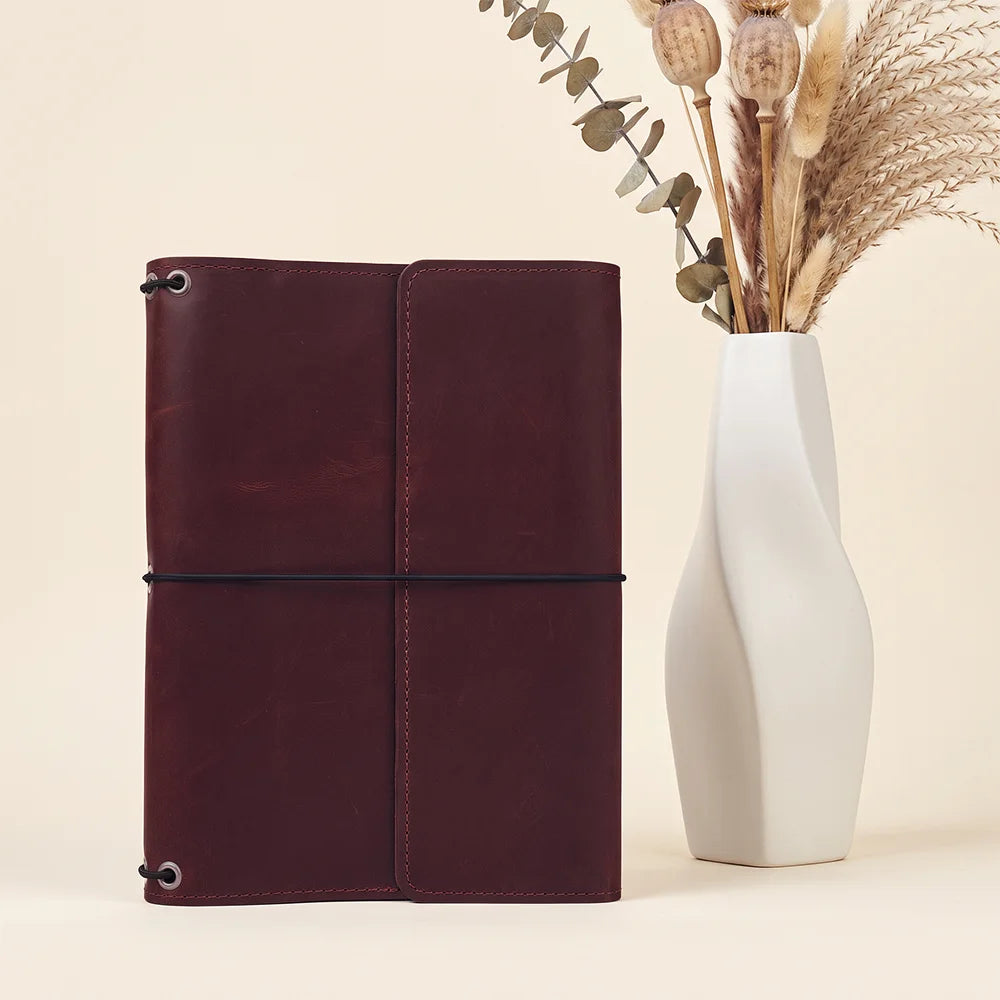 Leather writing portfolio with secure elastic notebook holders and convenient organizer pocket layout.