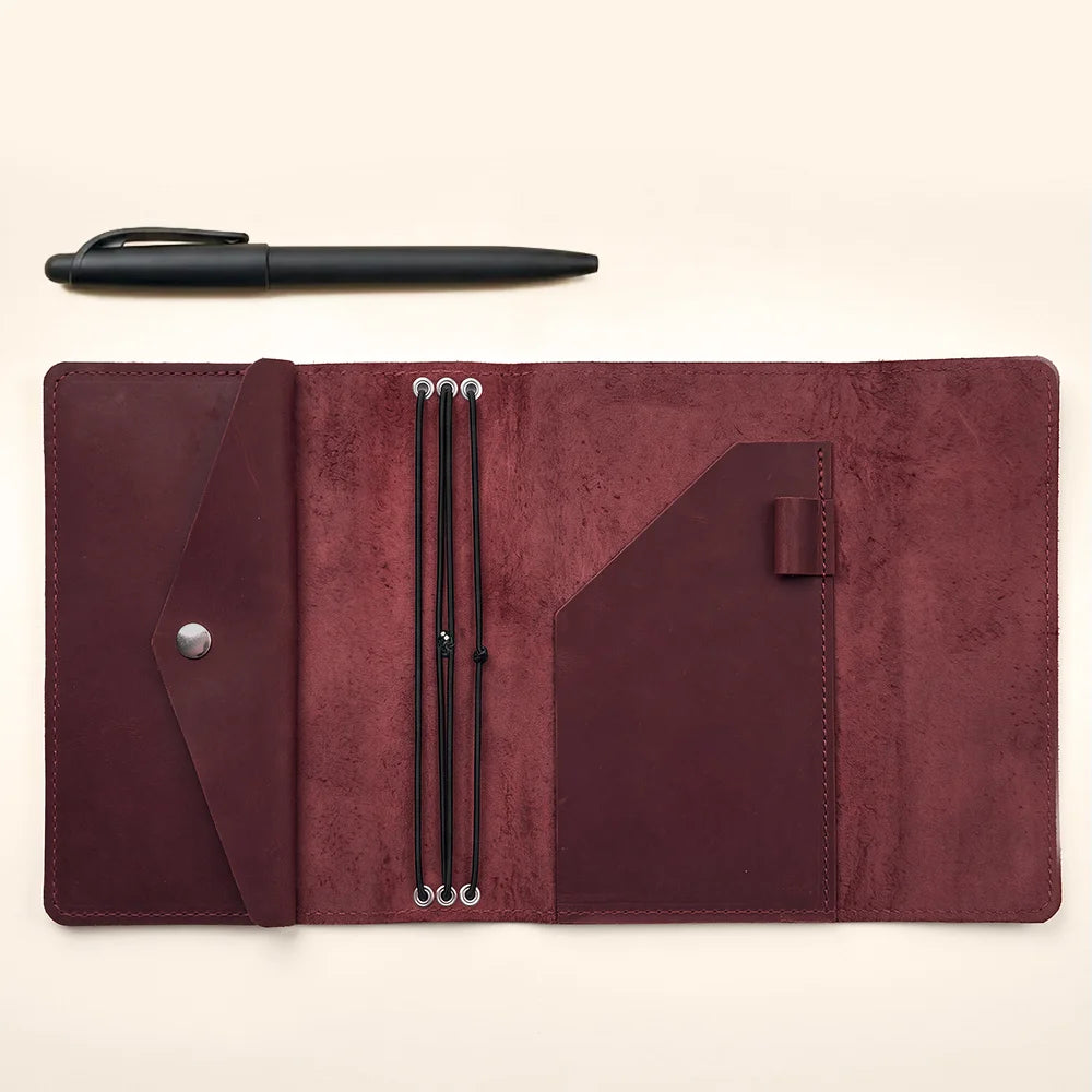 Handmade refillable leather journal cover with three elastic bands and practical inside pockets.