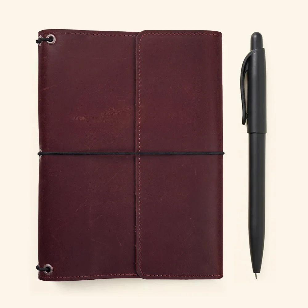 Genuine leather travel journal cover with three elastic bands and interior card compartments.