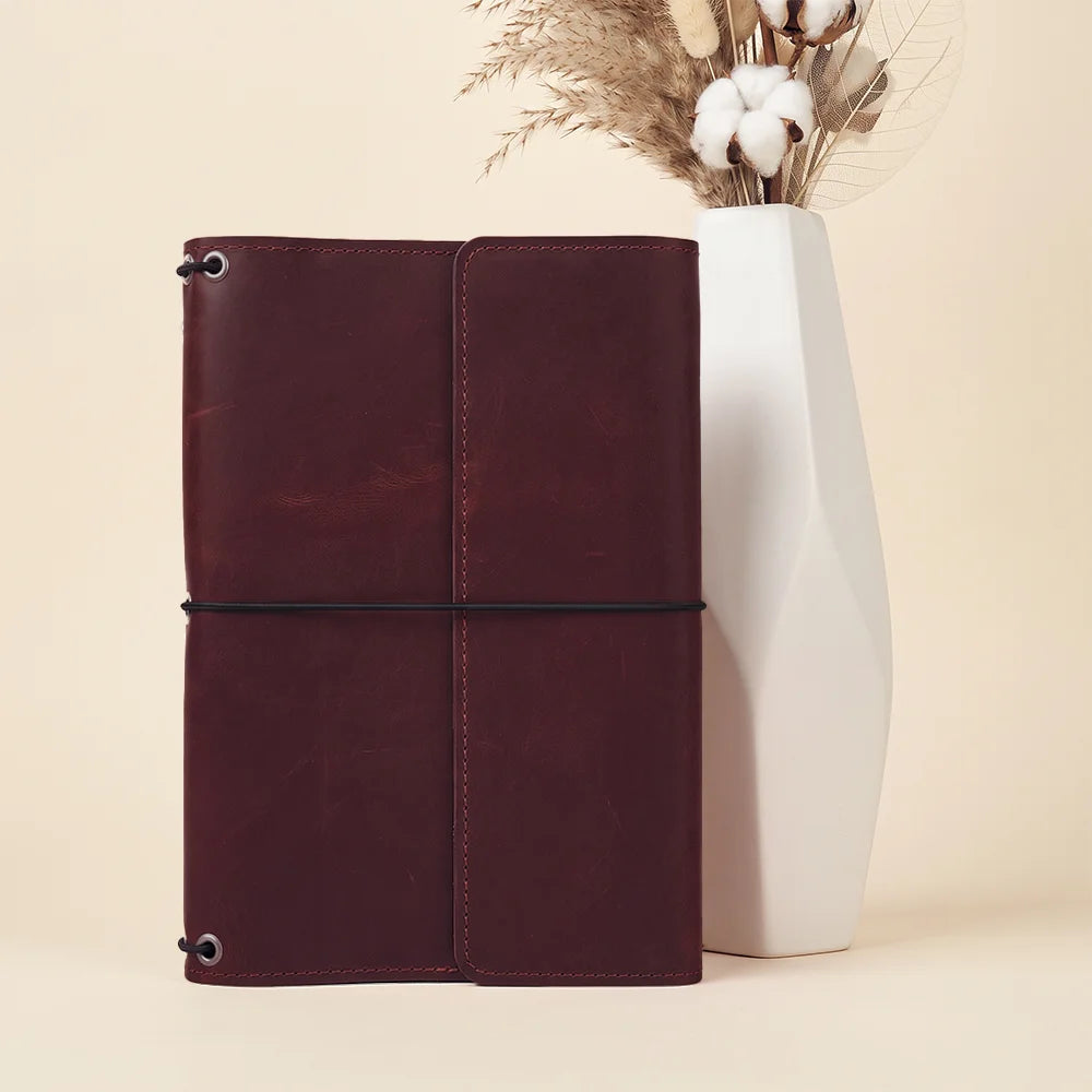 Full grain leather planner cover combining classic craftsmanship with modern refillable notebook convenience.
