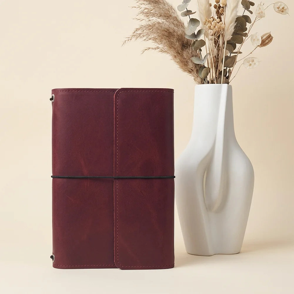 Natural leather journal organizer showing clean craftsmanship, functional pockets, and dedicated pen placement.