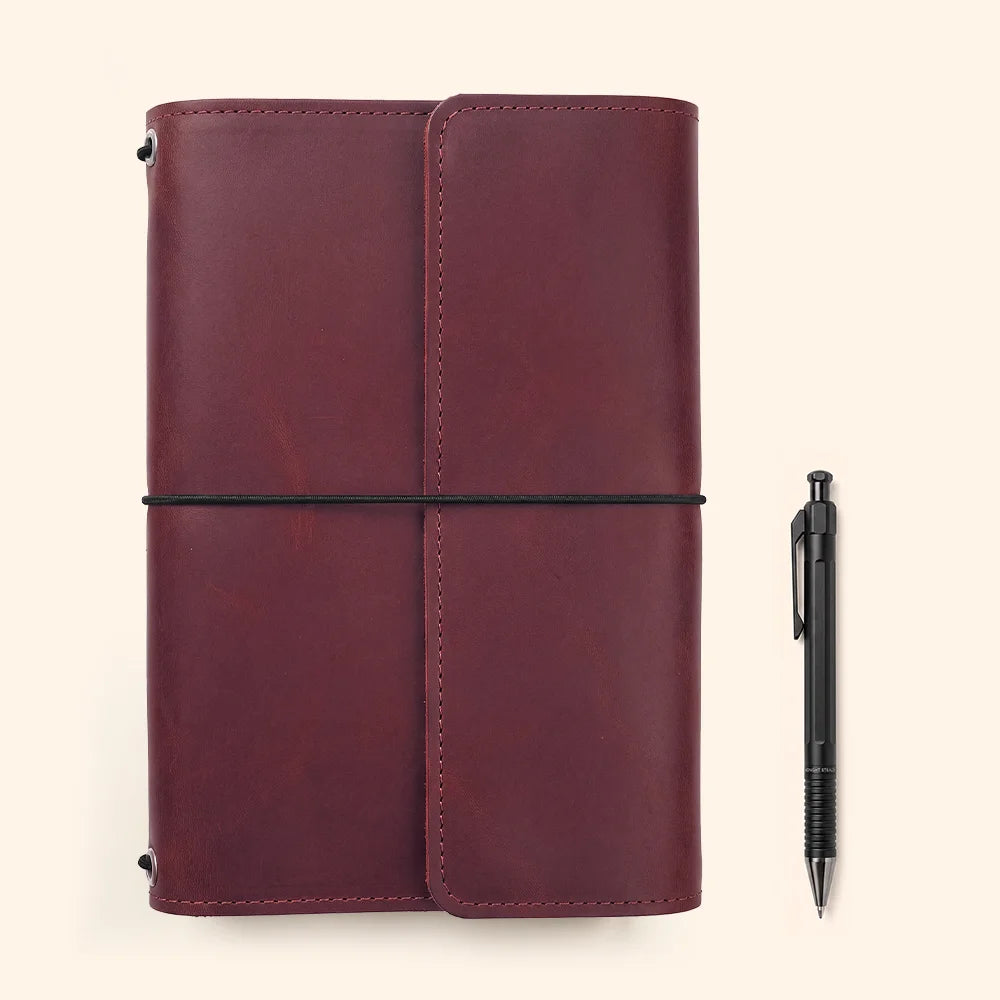 Handmade leather notebook sleeve featuring practical storage compartments and an integrated writing accessory loop.