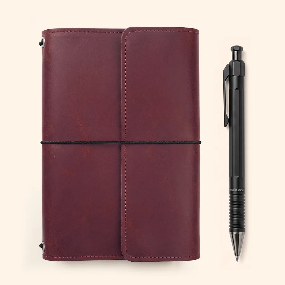 Leather journal sleeve showcasing carefully stitched interior pockets and a functional pen loop.