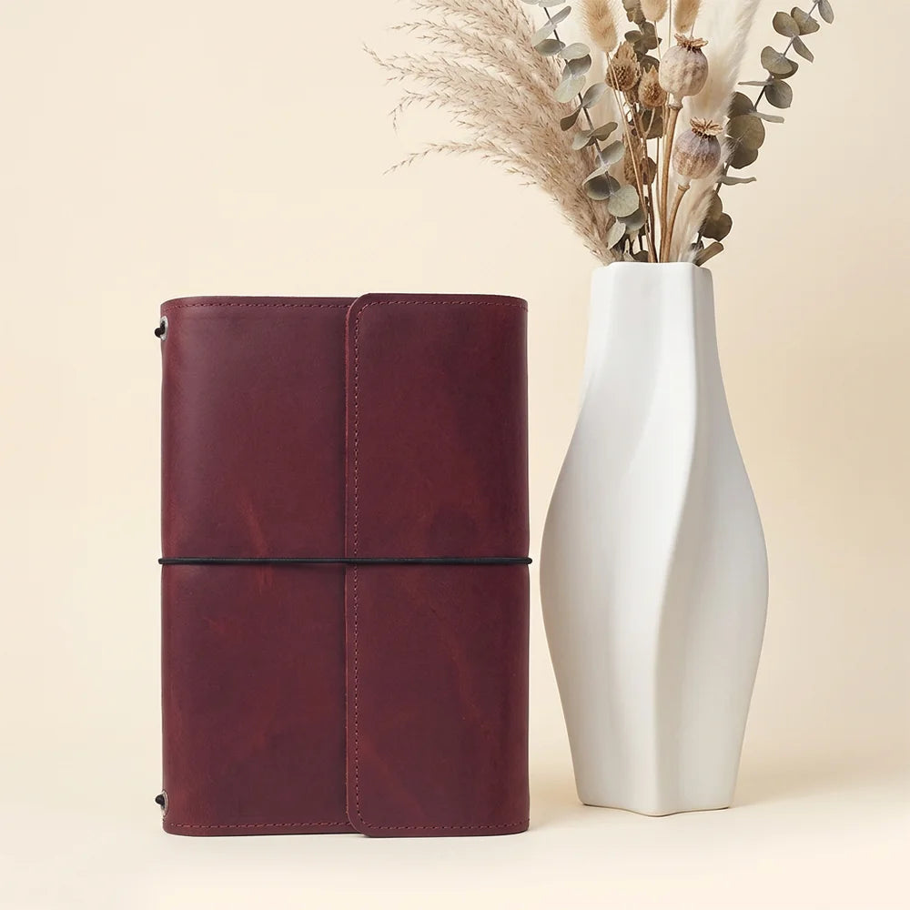 Genuine hide notebook cover featuring spacious compartments and dedicated storage for writing accessories.