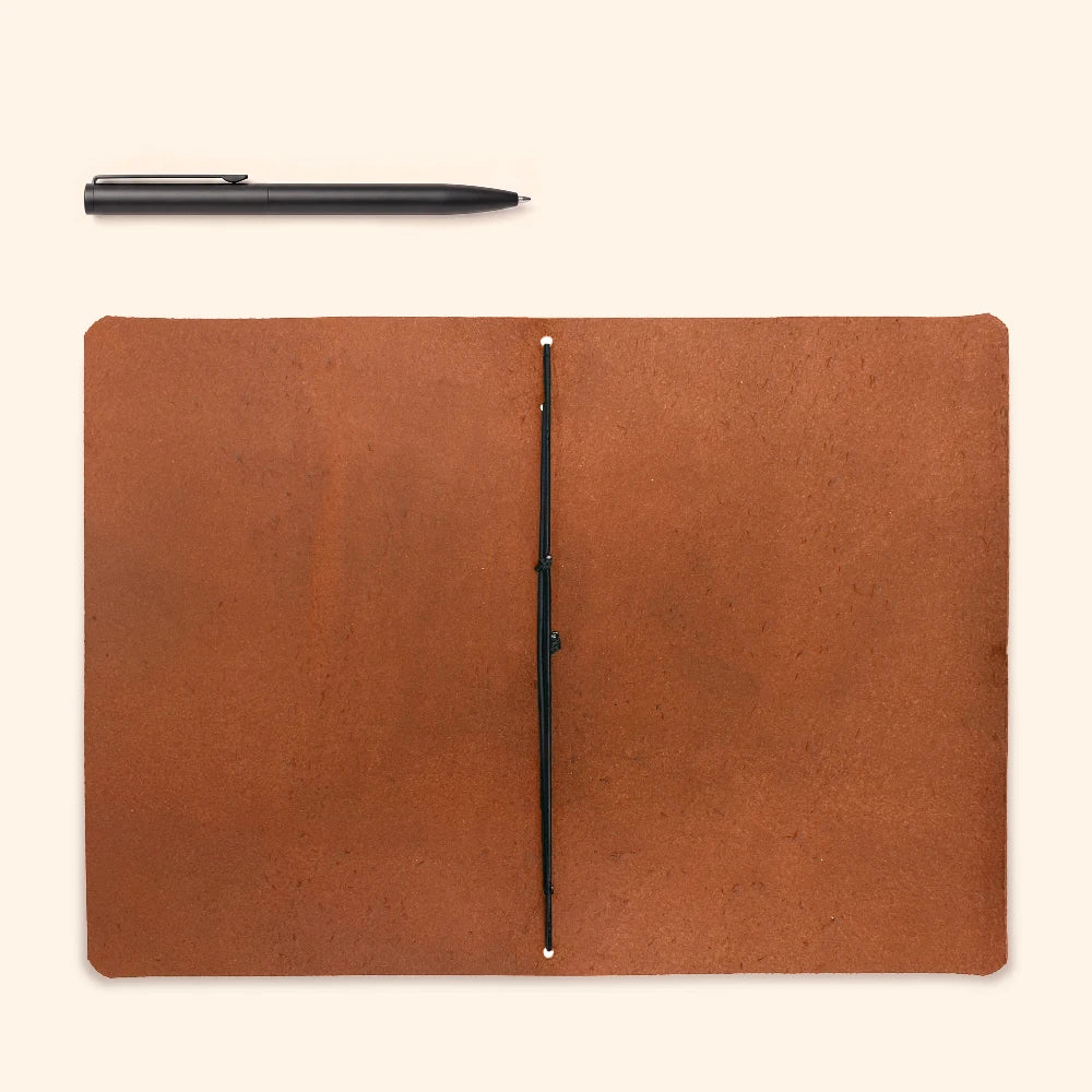 Handcrafted journal sleeve combining durable leather with a lightweight notebook insert.