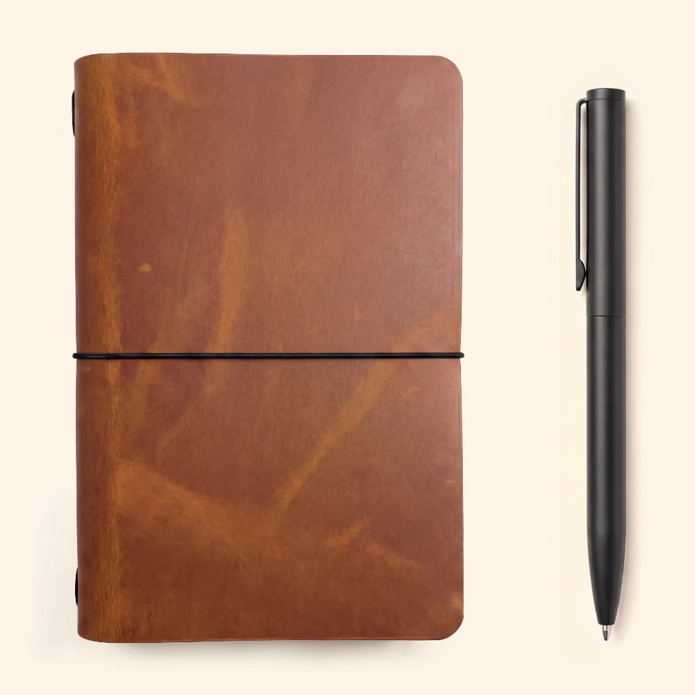 Natural leather writing sleeve designed around a simple notebook and minimalist function.