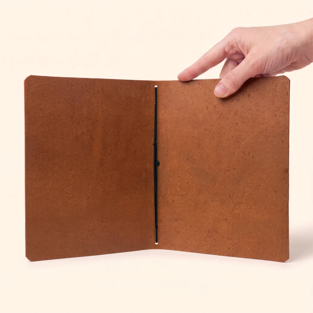Genuine leather journal organizer with minimalist interior and single elastic notebook holder.