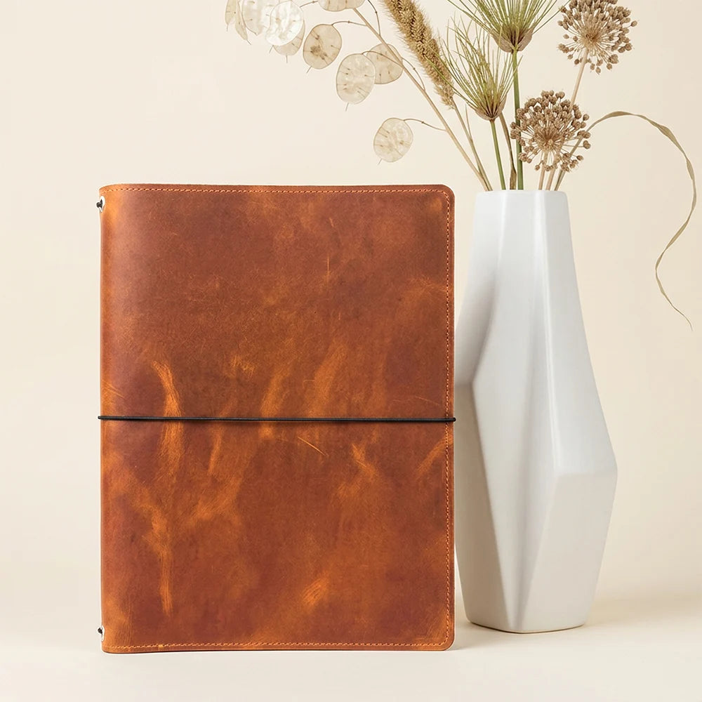 Natural leather organizer cover with multiple pockets and three elastic notebook straps.