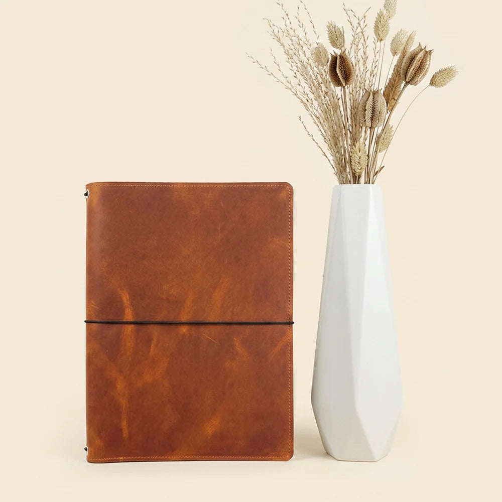 Handmade leather sketchbook organizer with practical pockets, elastic loops, and notebook fastening.
