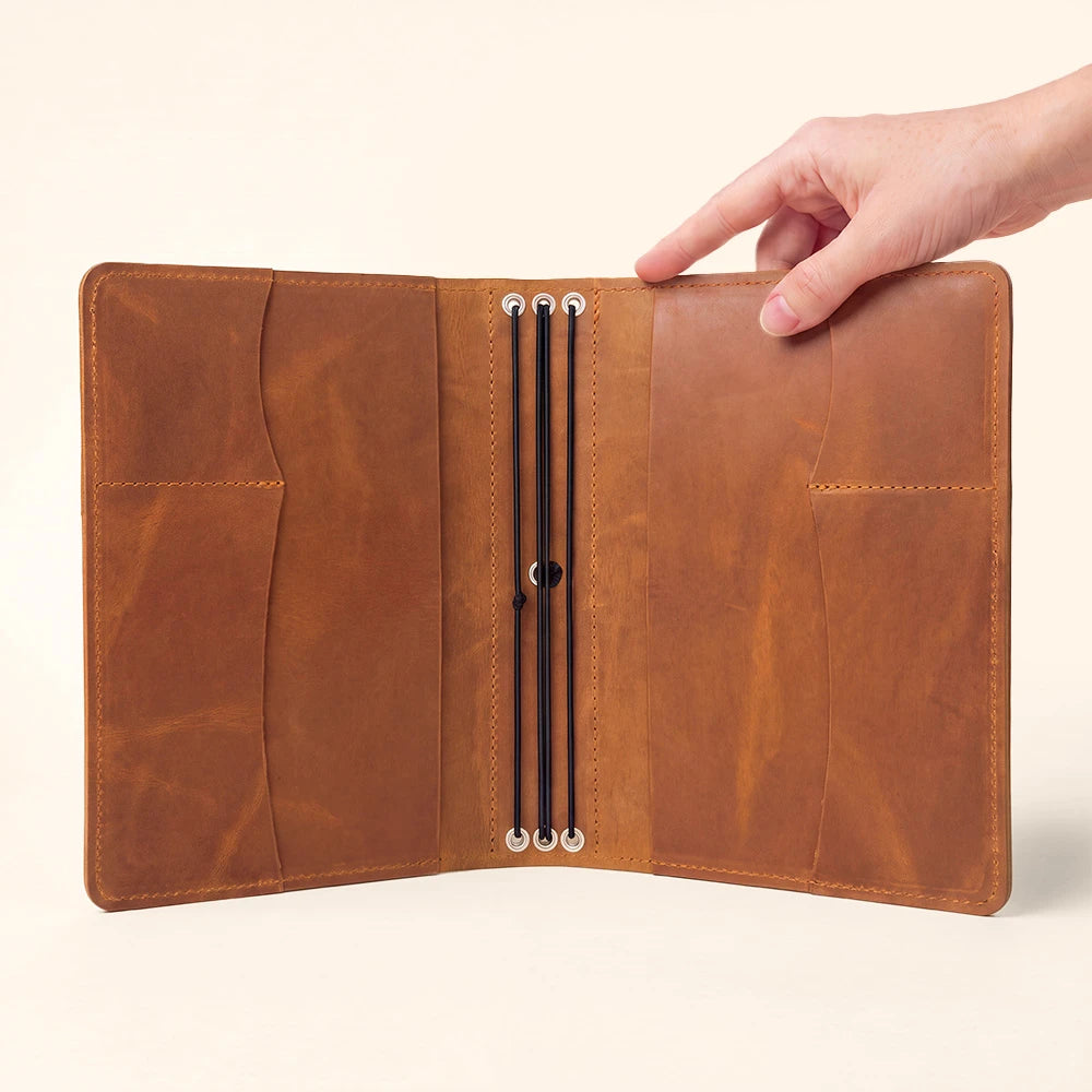 Leather notebook portfolio designed with interior organization and integrated pen storage.