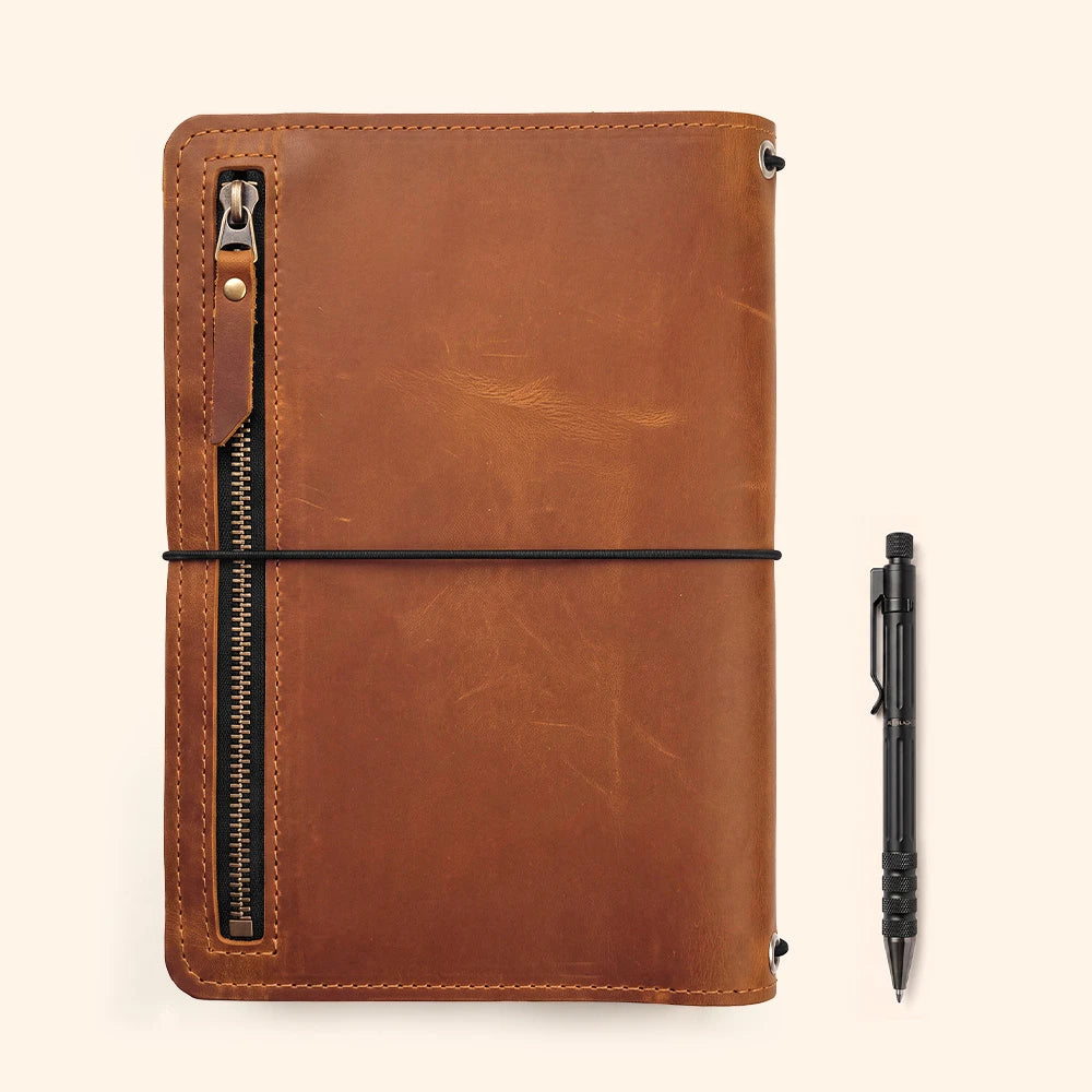 Leather notebook cover offering refined craftsmanship with convenient document and pen storage.