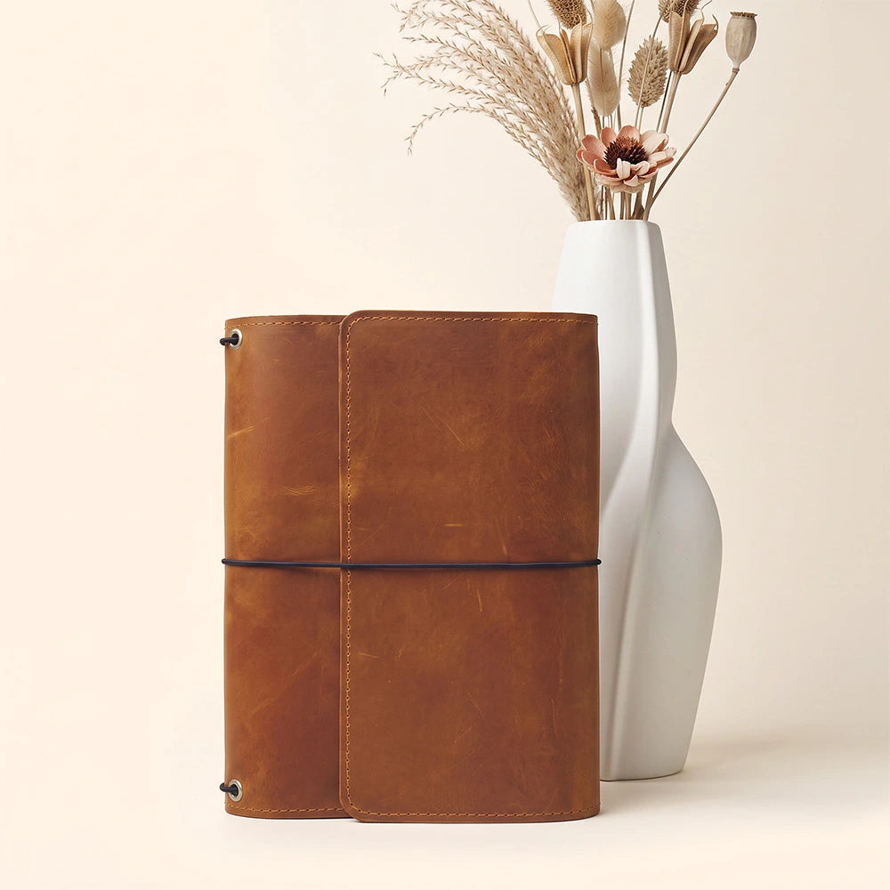Leather notebook organizer offering efficient storage layout and practical leather pen attachment feature.
