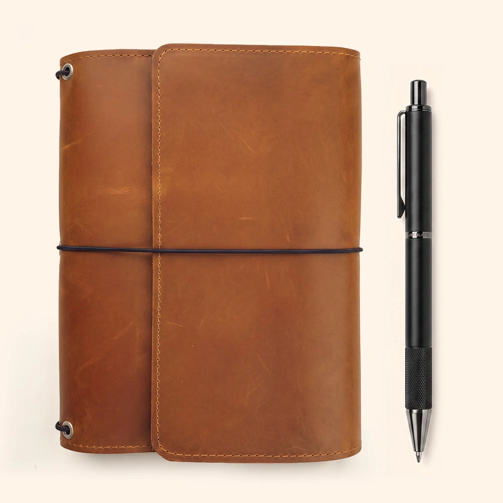 Handmade leather writing organizer with storage pockets and integrated leather pen sleeve.