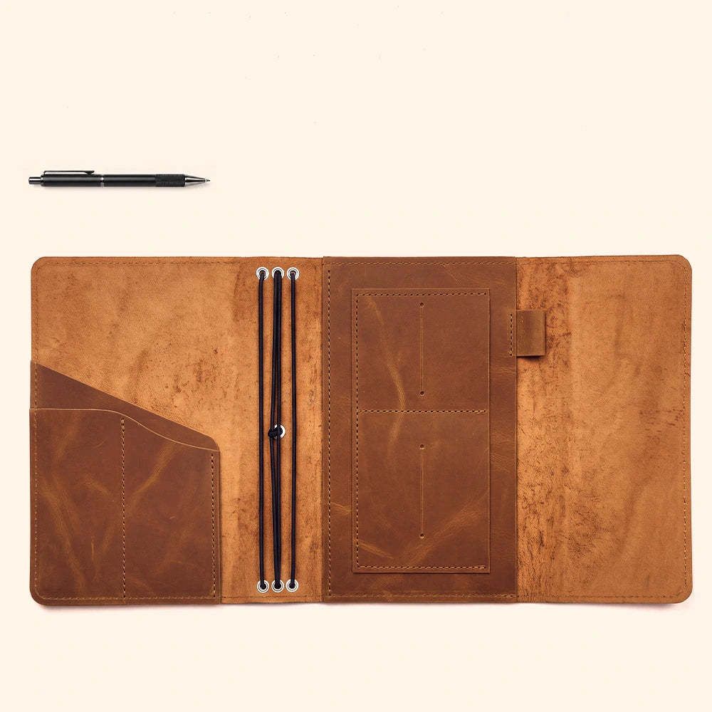 Leather writing folio crafted with organized document sleeves and convenient leather pen strap.