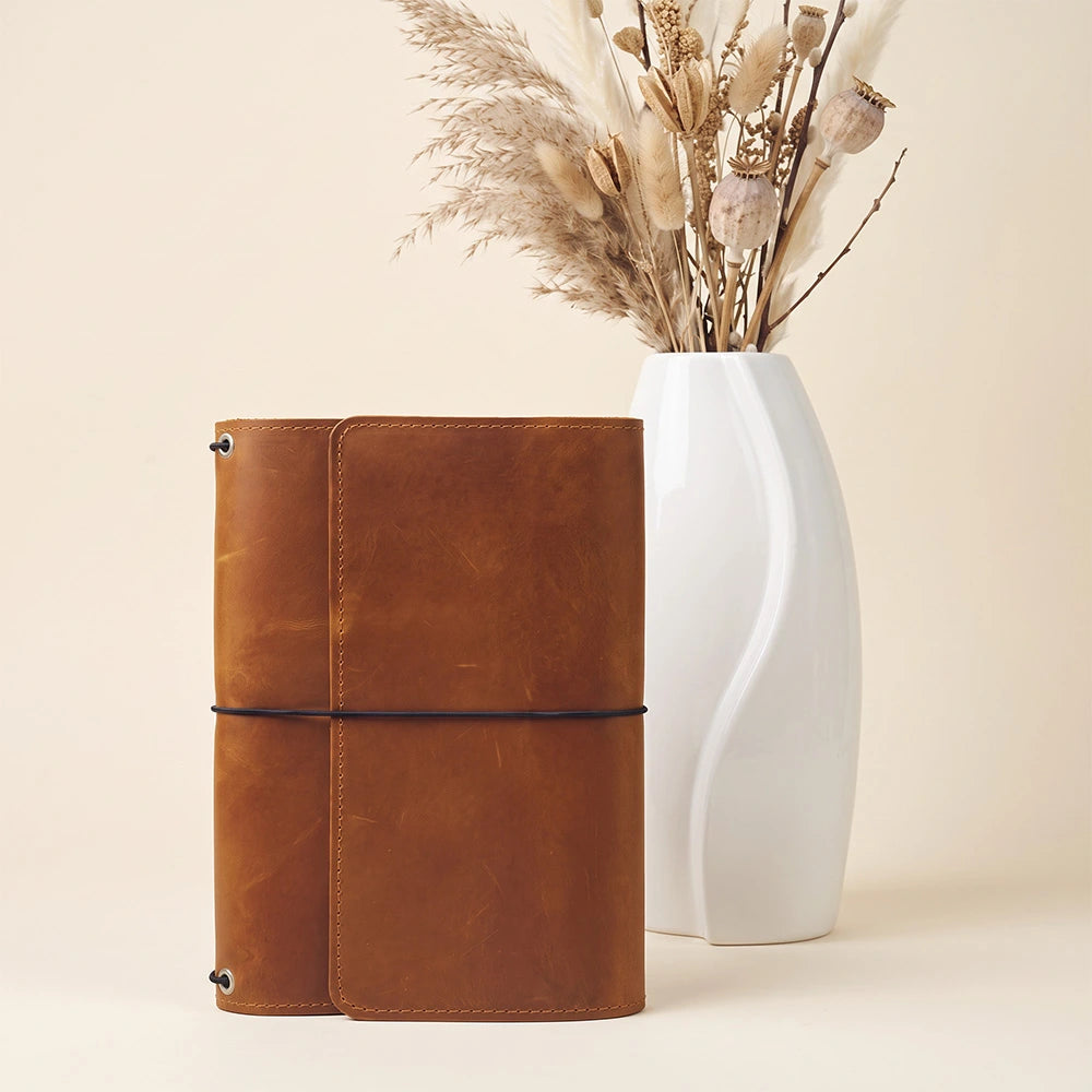 Rustic leather notebook portfolio featuring interior card organizers and built-in pen retaining loop.