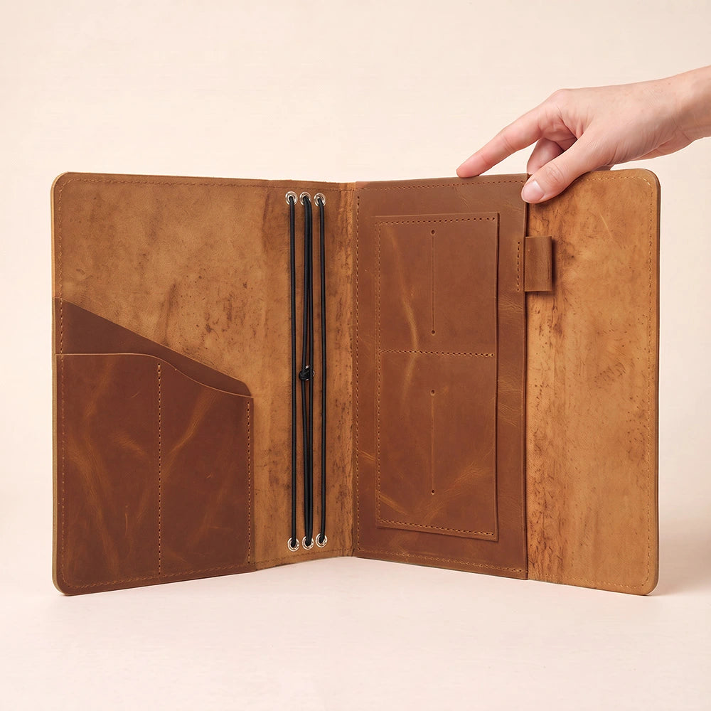 Handcrafted leather notebook wallet with spacious inner storage and elegant pen holder design.