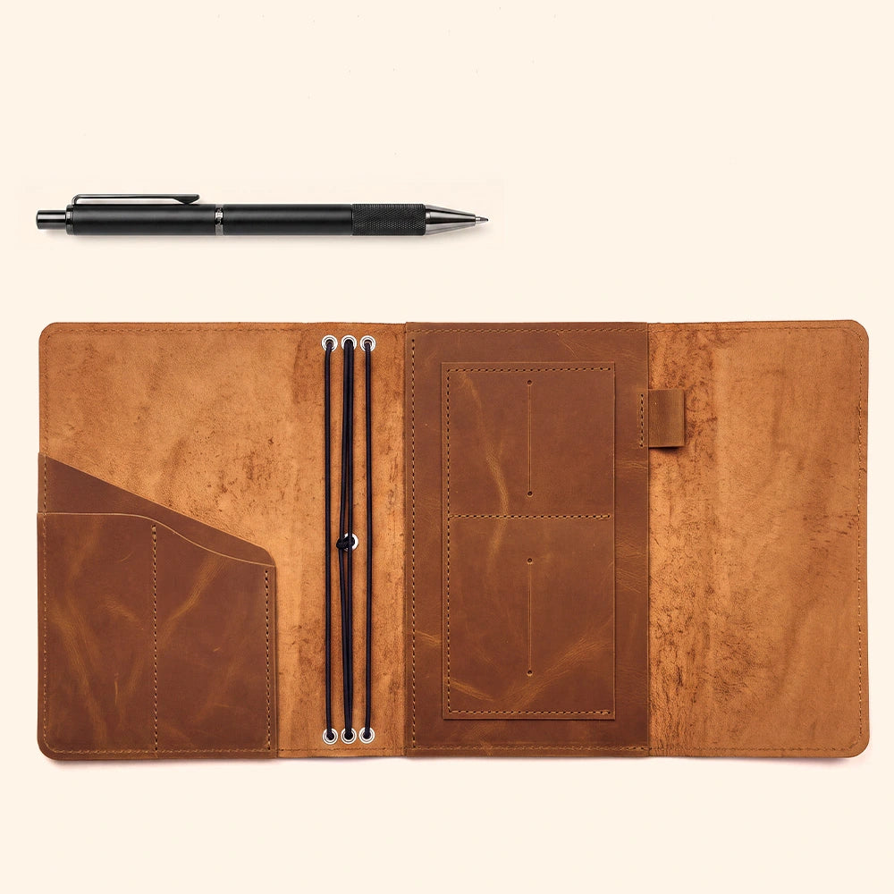 Handmade leather cover featuring practical inside pockets and elegant leather pen loop design.