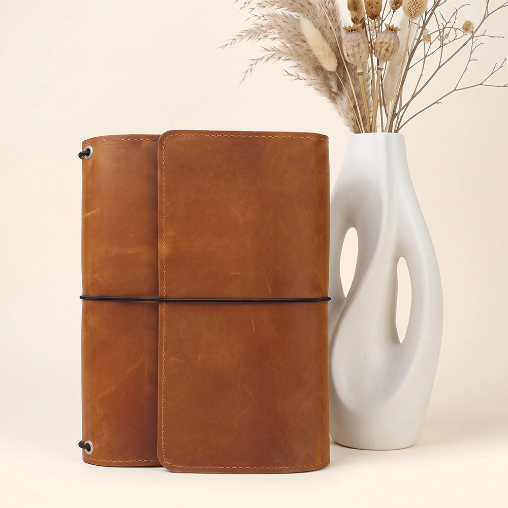 Genuine leather notebook organizer with interior card pockets and secure pen holder included.