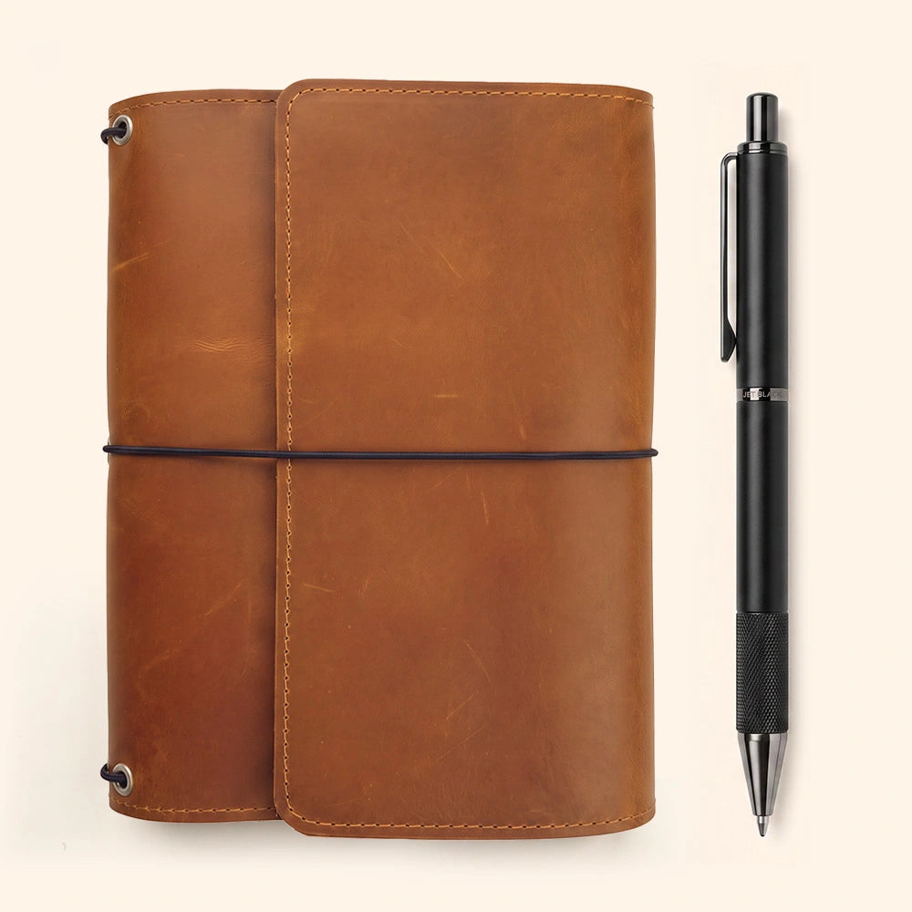 Leather notebook cover with organized interior storage and integrated leather pen holder feature.