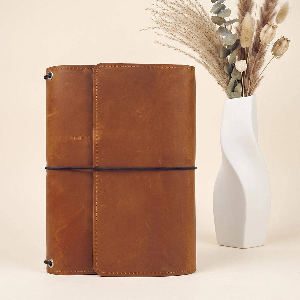 Genuine leather cover with interior organizer pockets and convenient pen loop for notebooks.
