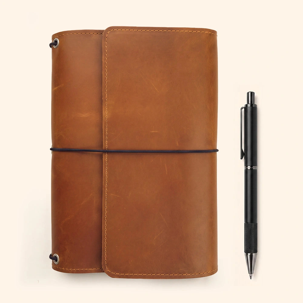 Genuine leather writing notebook cover with organized storage and secure integrated pen strap.