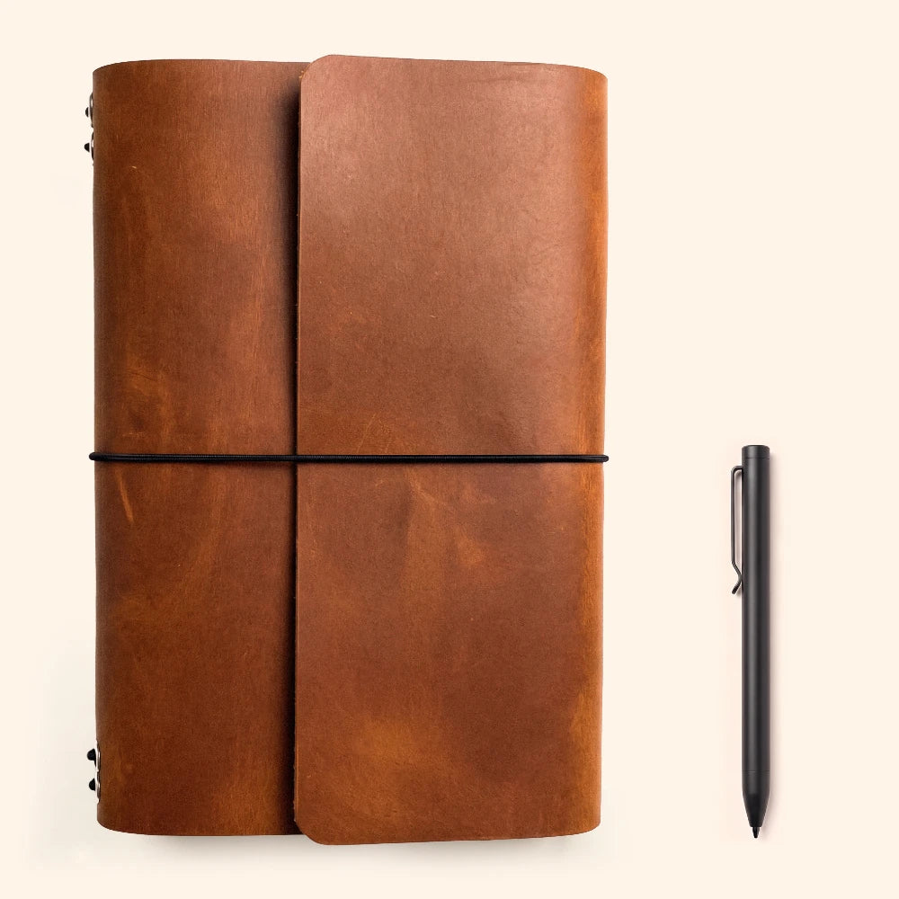 Genuine leather notebook carrier offering six interchangeable insert spaces and pen storage.