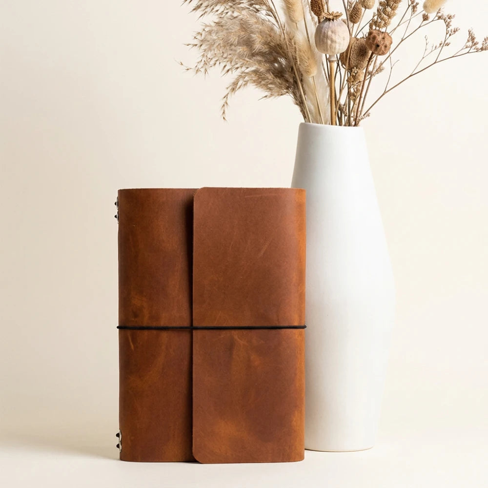Premium leather notebook organizer featuring six elastic straps for versatile insert storage.