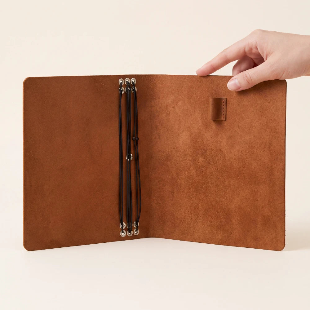 Elegant genuine leather journal cover with six elastic bands and practical pen holder.