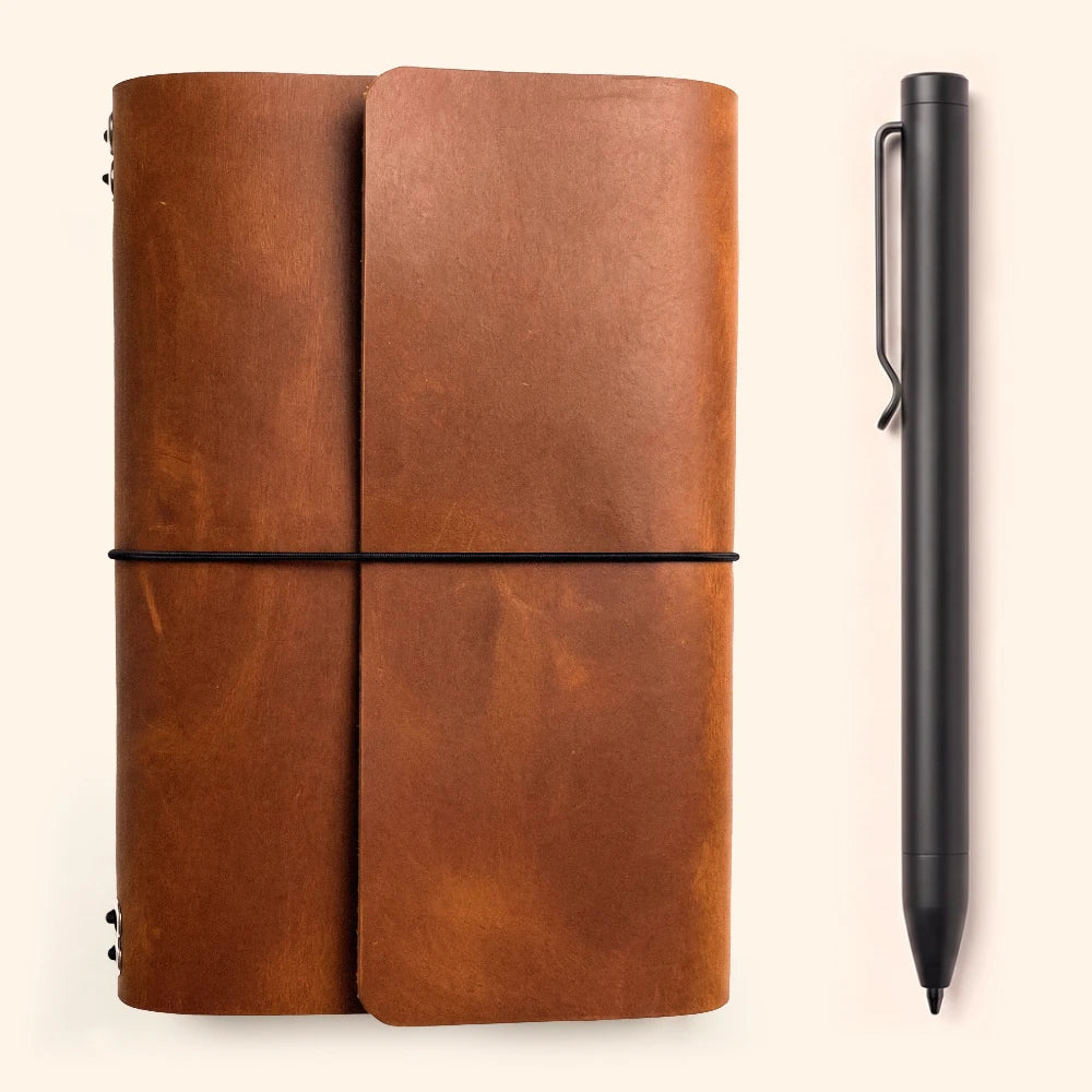 Genuine leather notebook sleeve with six elastic bands and an integrated pen holder.