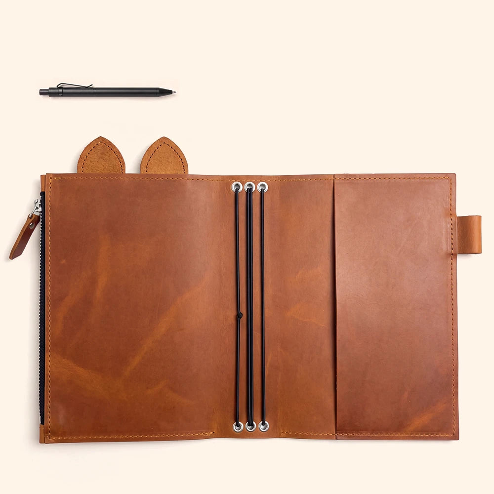 Leather organizer with decorative ears, pen loop, and spacious zipper pocket.