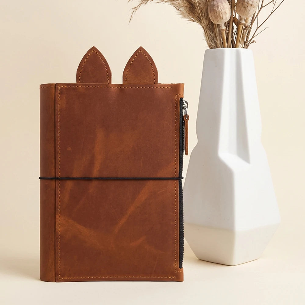 Handcrafted leather planner case featuring rich texture, precise stitching, and practical storage.