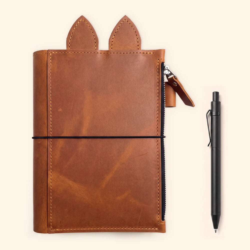 Leather journal cover with three elastic holders positioned neatly along the center.