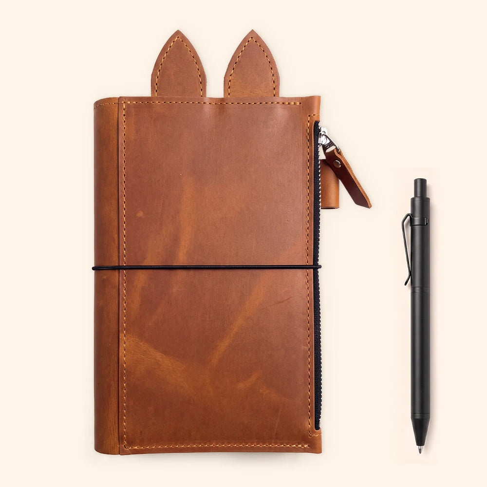 Leather journal holder combining soft texture, elastic inserts, and organized storage.