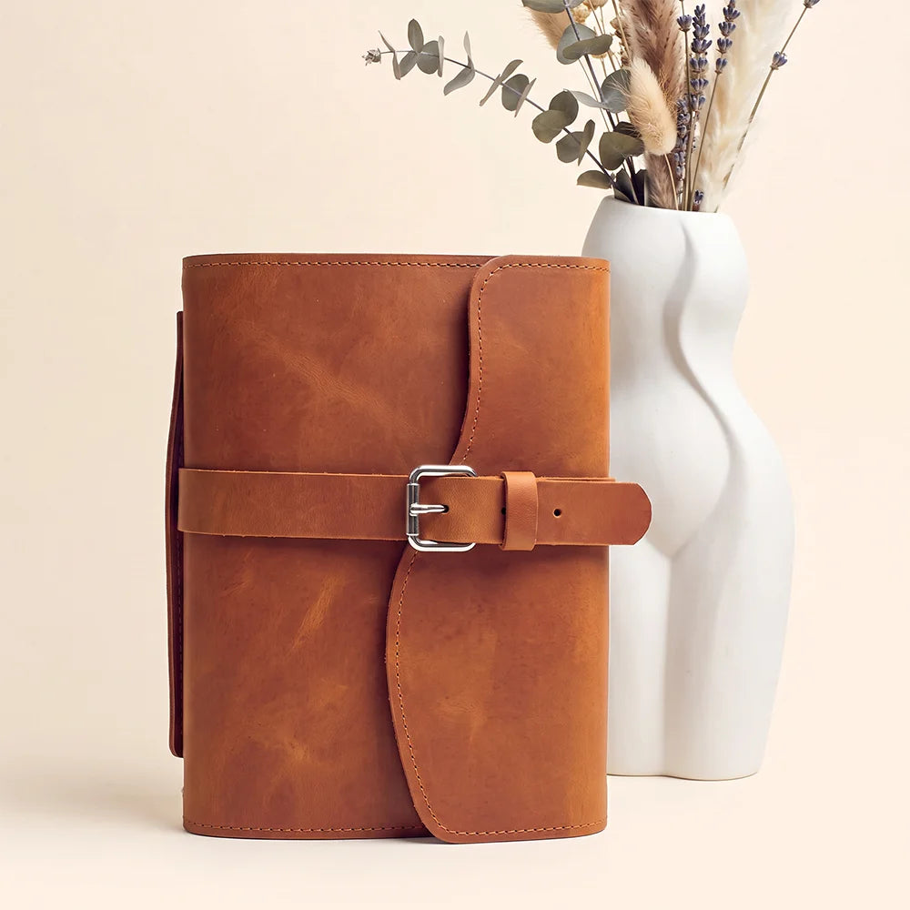 Handcrafted natural leather journal cover with pockets, pen loop, page marker, and comfortable external handle.