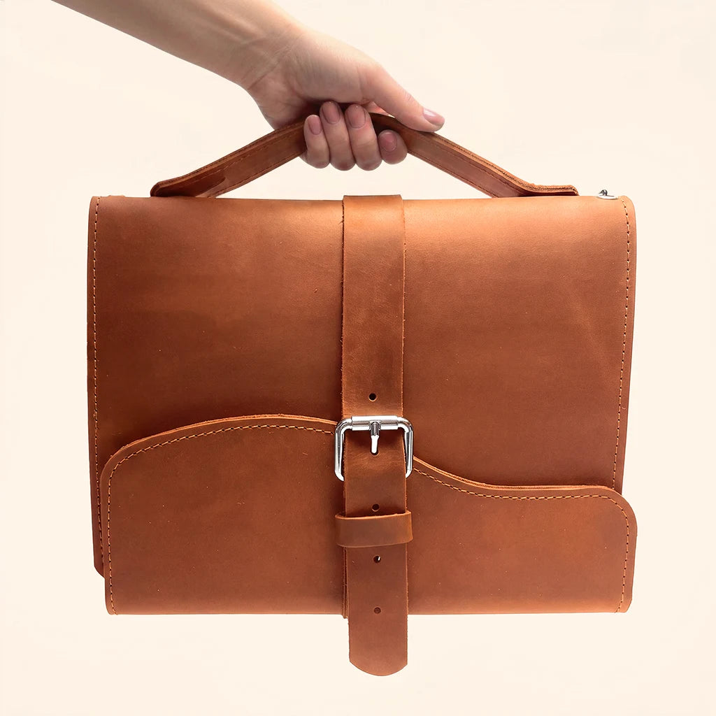 Stylish genuine leather notebook cover featuring triple elastic bands for organizing inserts.