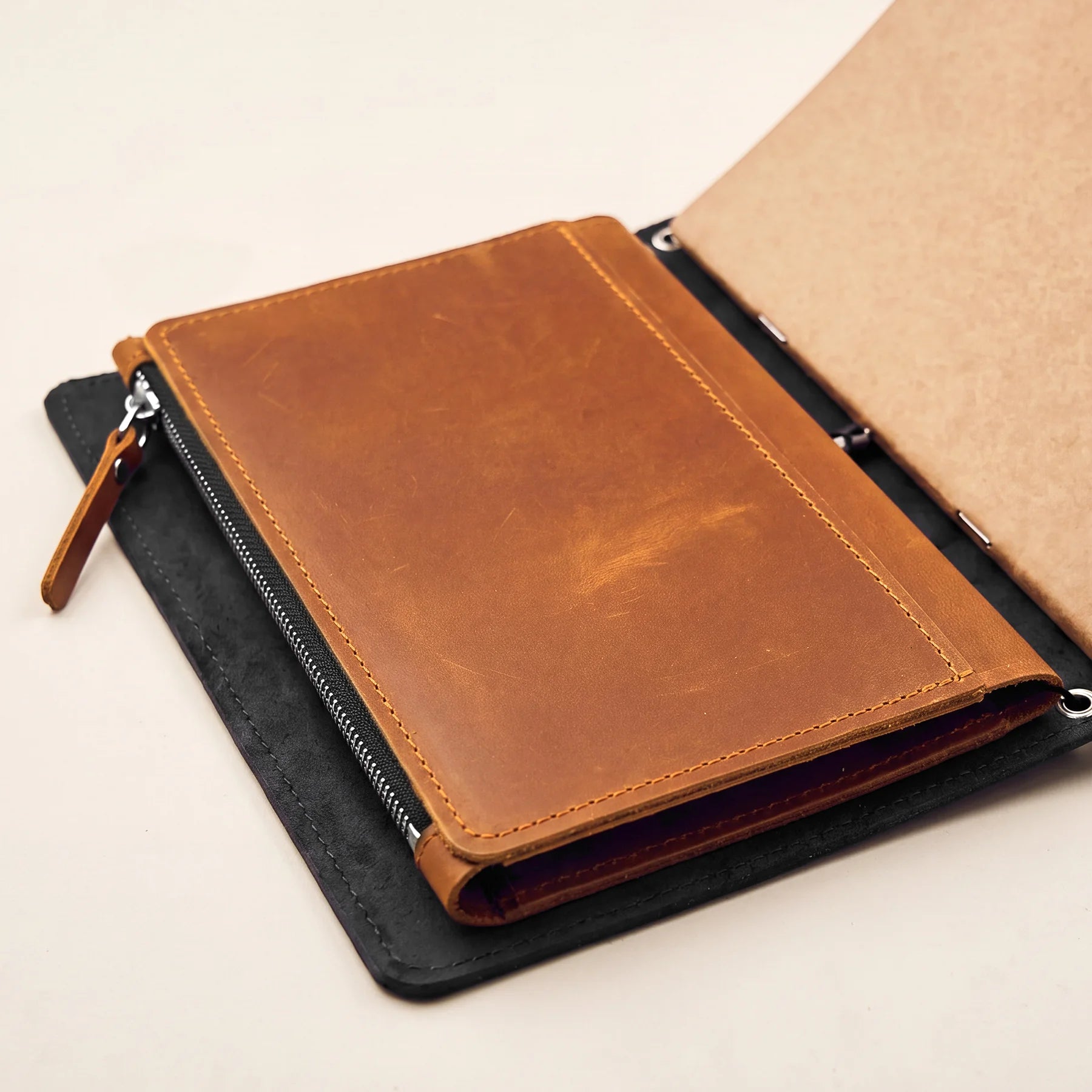 Leather notebook insert accessory for refillable journals with elastic band compatibility.