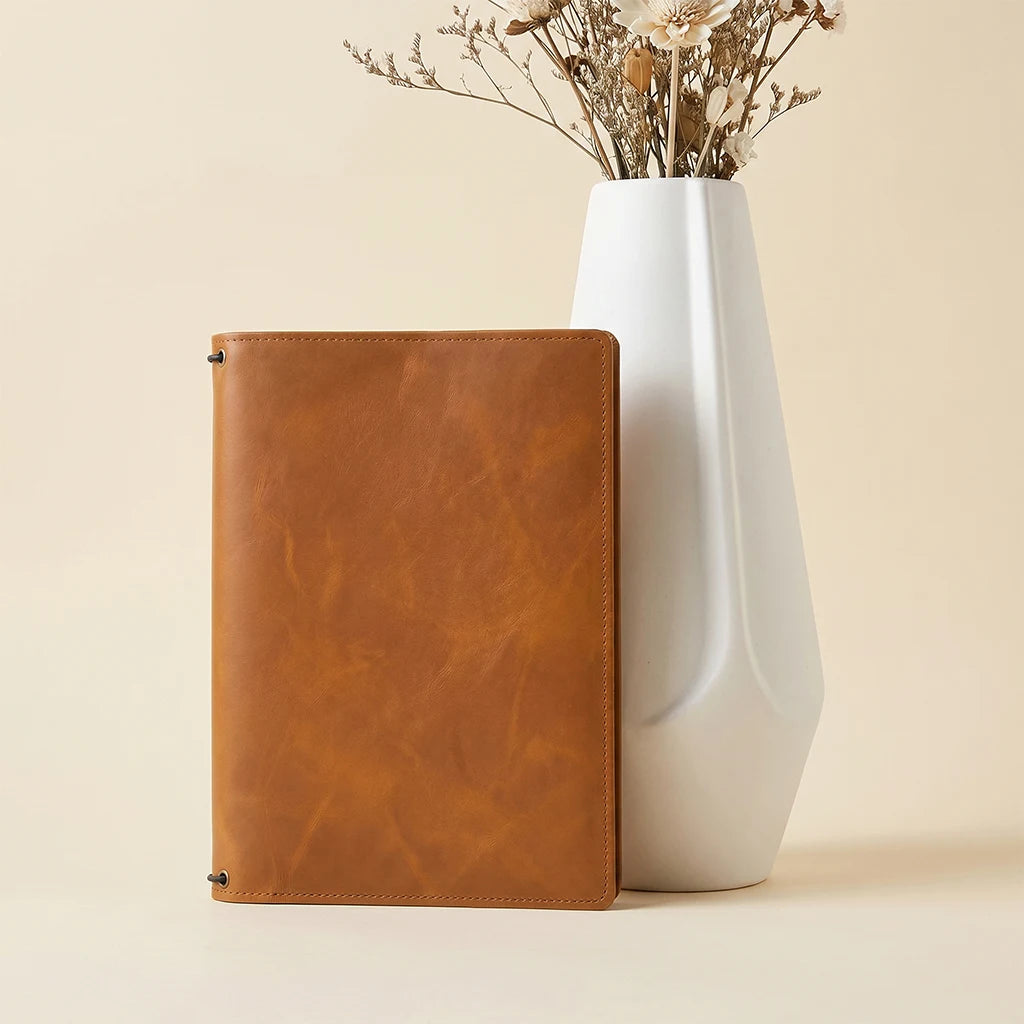 Handcrafted leather folio designed to keep notebooks and essentials together.