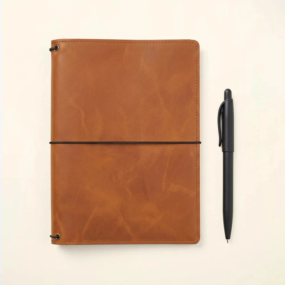 Leather notebook organizer with handcrafted quality and secure elastic refillable notebook design.
